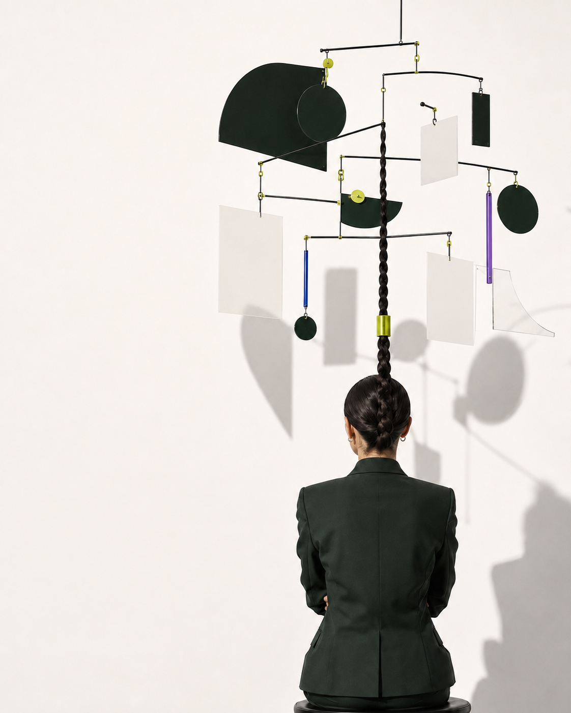 A leader facing a carefully balanced mobile, representing the many parts of marketing she has to hold together.